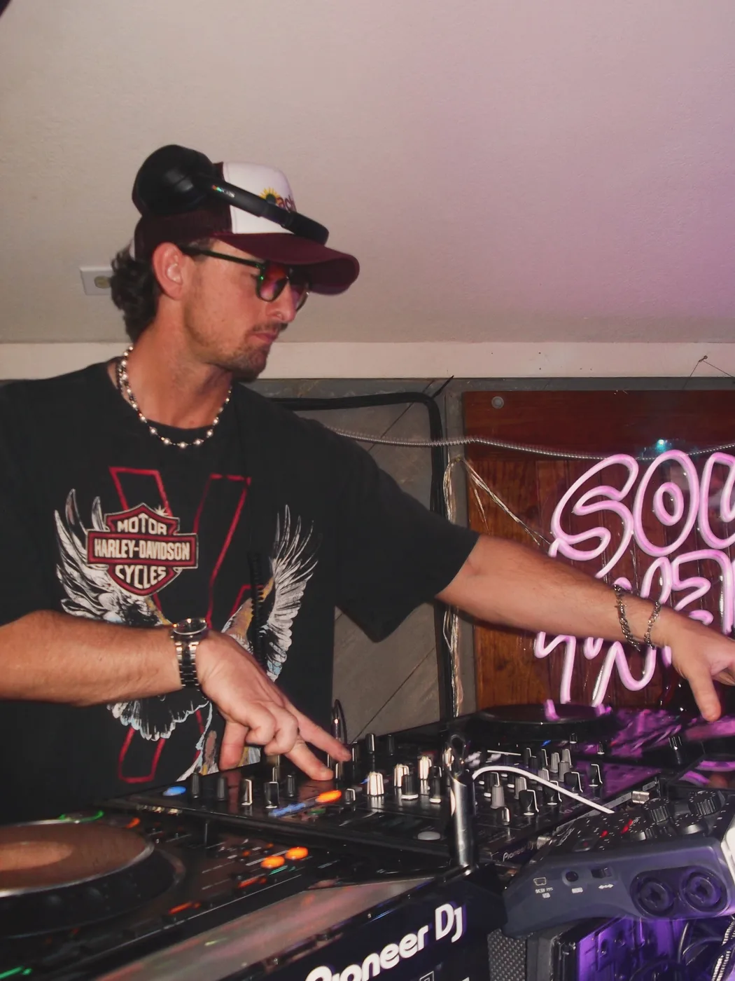 AUSTAL DJing under pink stage lighting